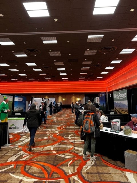 The exhibit hall with milling around the tables