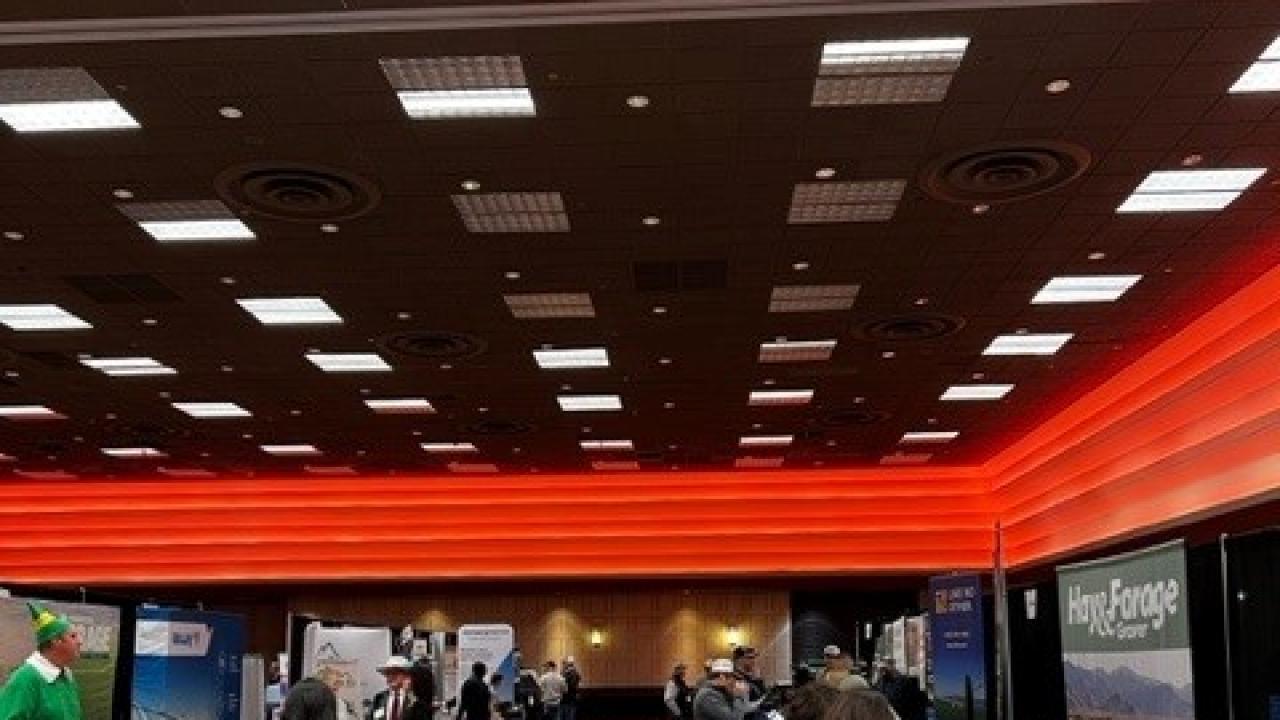 The exhibit hall with milling around the tables